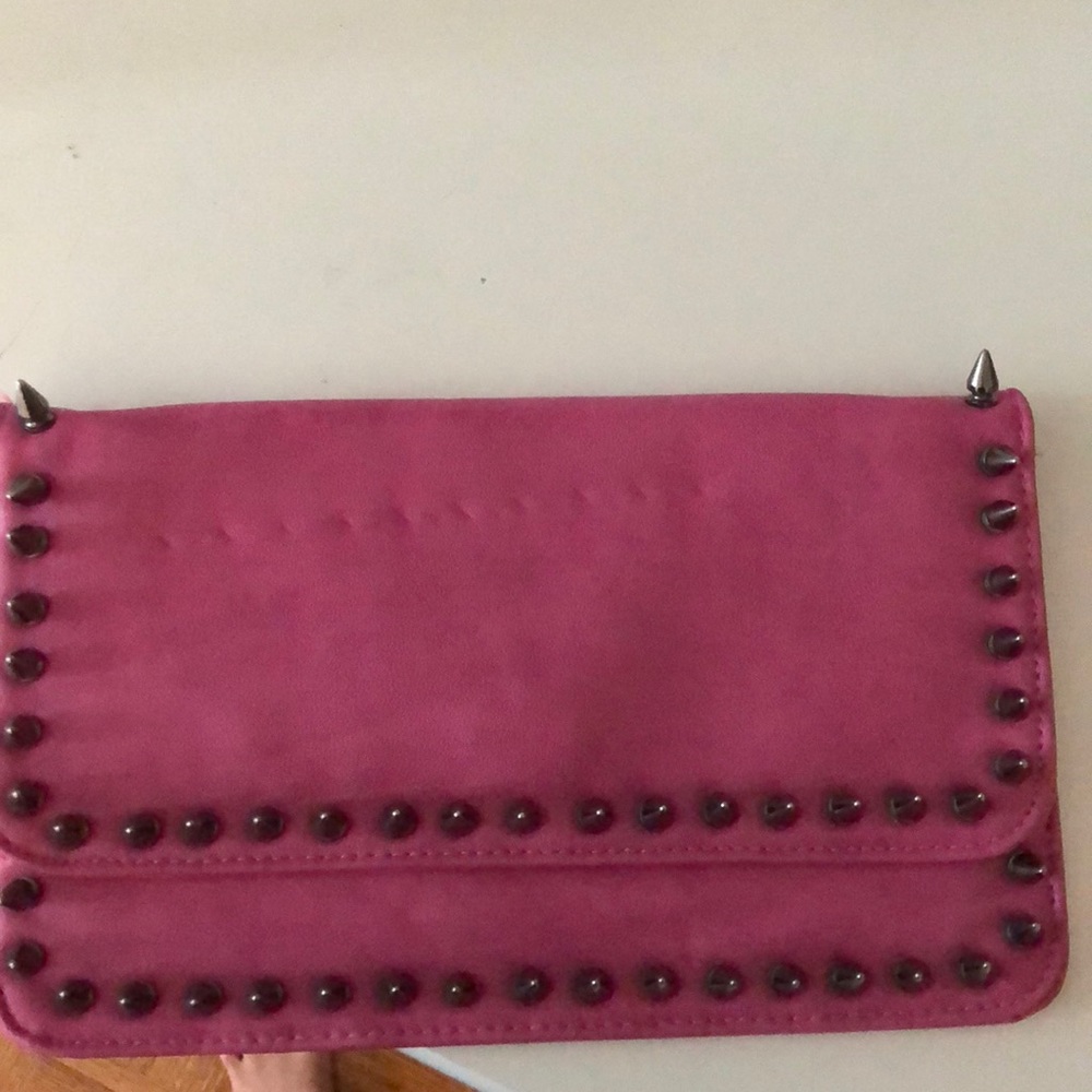 Pink clutch with gunmetal spikes